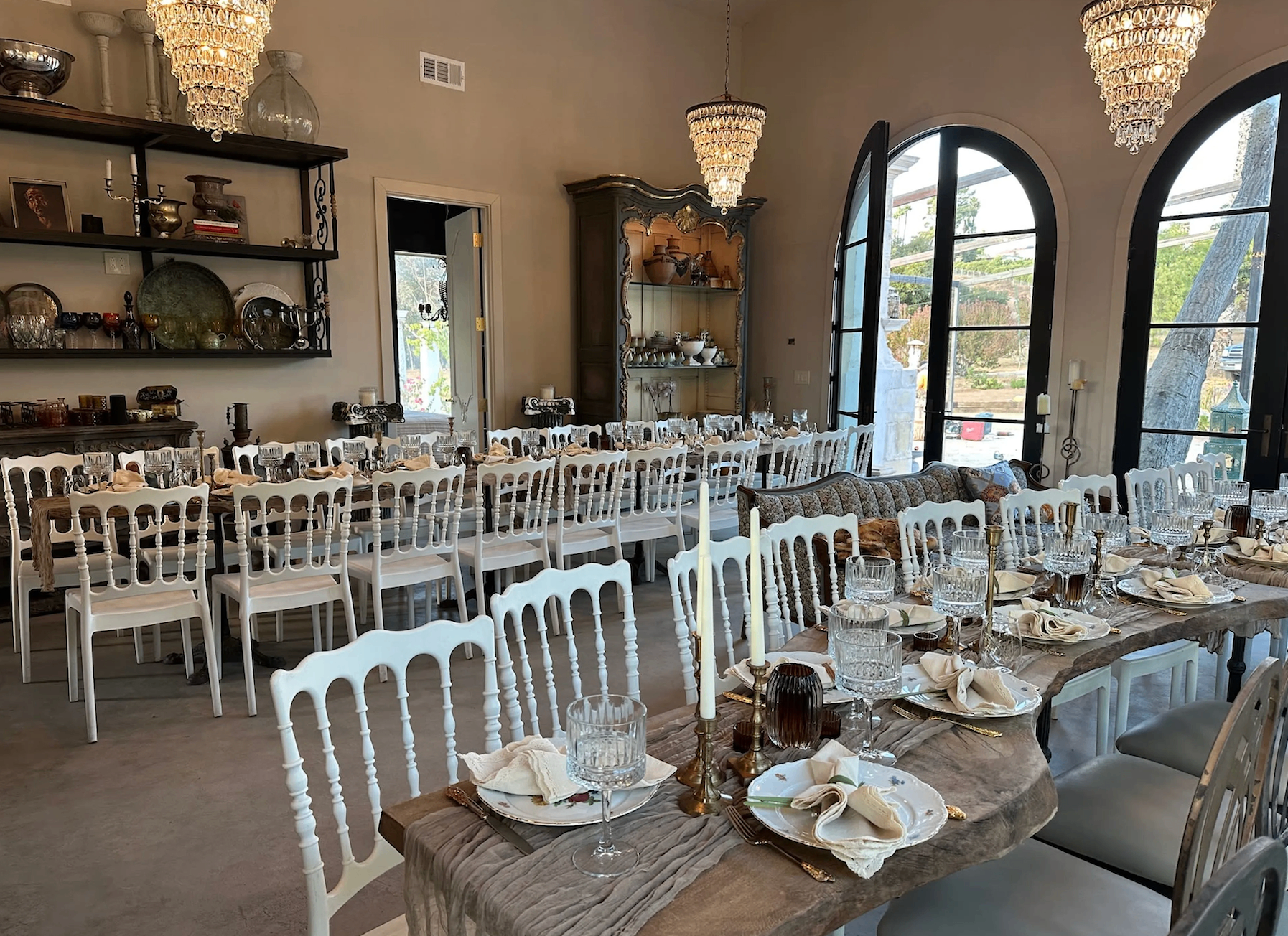 Elegant dining room with chandeliers and long wooden table